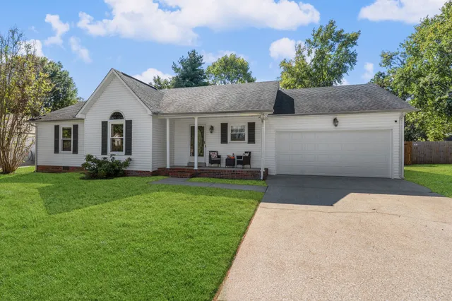 a front view of house with yard and green space