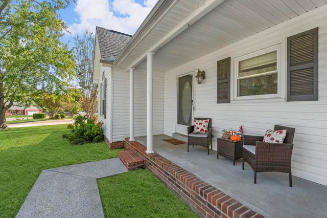 a backyard of a house with outdoor seating