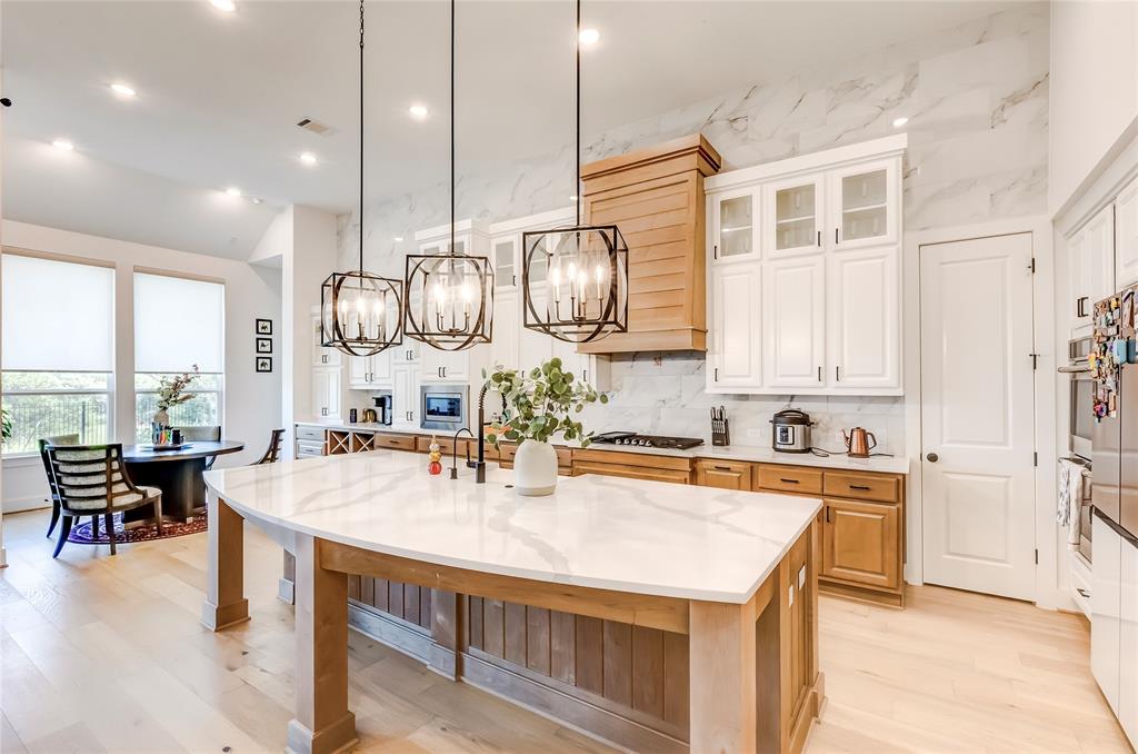 126 LITTLE Strm Cove Austin, TX 78737 - Photo 11 of 40 A light wood kitchen island with a white countertop centers this well-lit open-concept space.