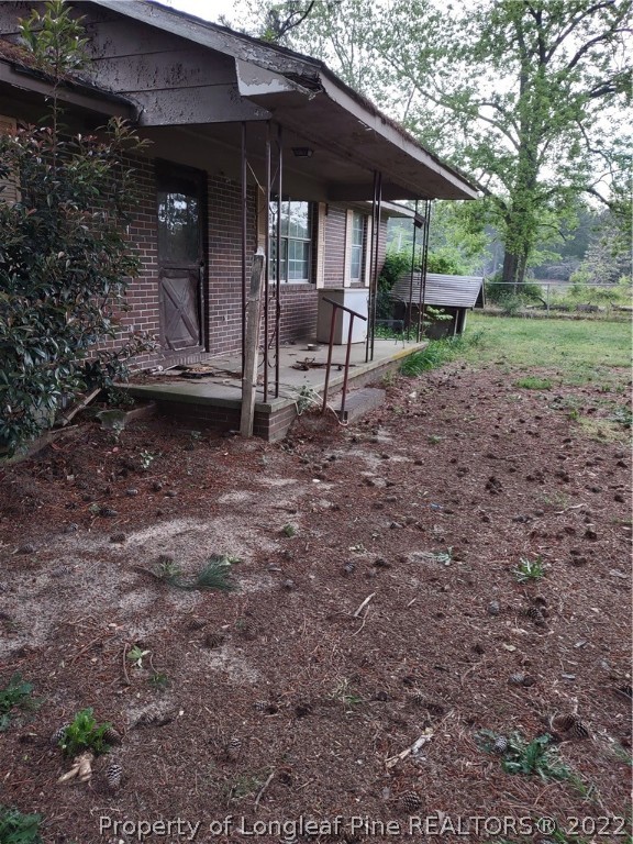 264 Freeman Mill Road Hamlet, NC 28345 - Photo 7 of 18 a view of a house with backyard and sitting area