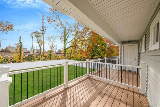 a view of balcony with wooden floor