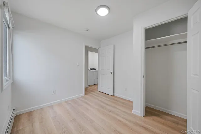 an empty room with wooden floor and closet