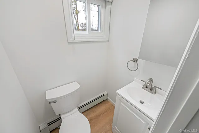 a white toilet sitting next to a white sink