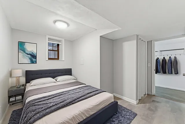 a bedroom with a bed and wall painting