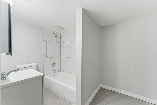 a view of bathroom with a tub sink and mirror