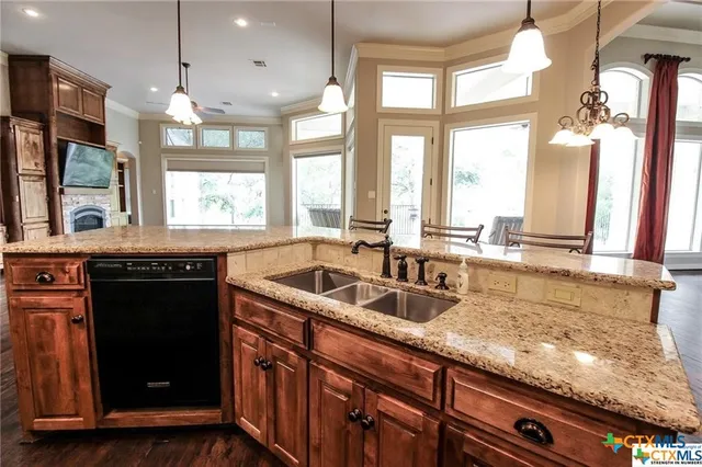a kitchen with granite countertop a sink and a counter top space