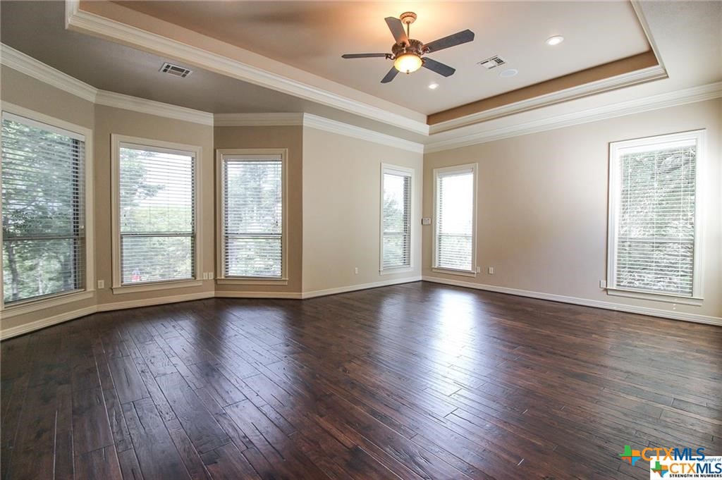 10286 Hartrick Bluff Road Temple, TX 76502 - Photo 29 of 46 a view of an empty room with wooden floor and a window