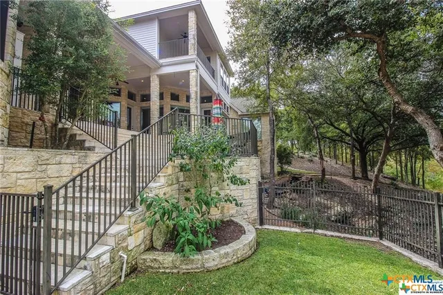 a view of a house with a small yard and plants