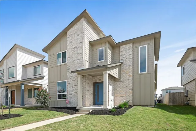 a front view of a house with a yard