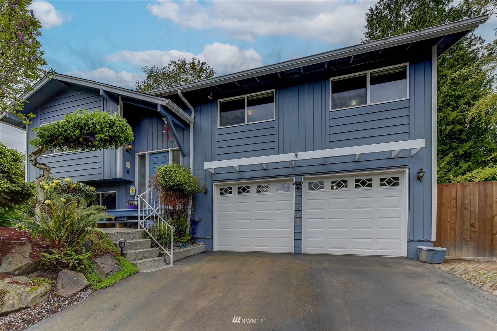 22028 5th Avenue West Bothell, WA 98021 - Photo 1 of 19 a front view of a house with a garden