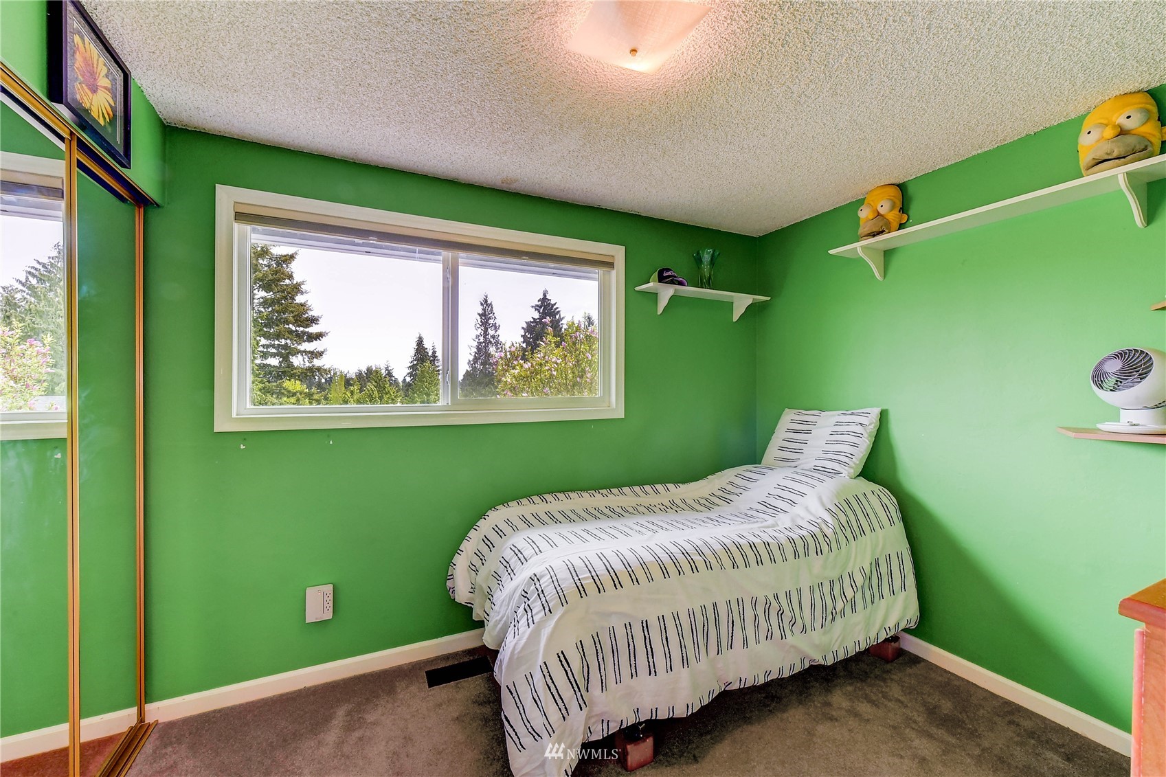 22028 5th Avenue West Bothell, WA 98021 - Photo 11 of 19 a bed sitting in a bedroom next to a window