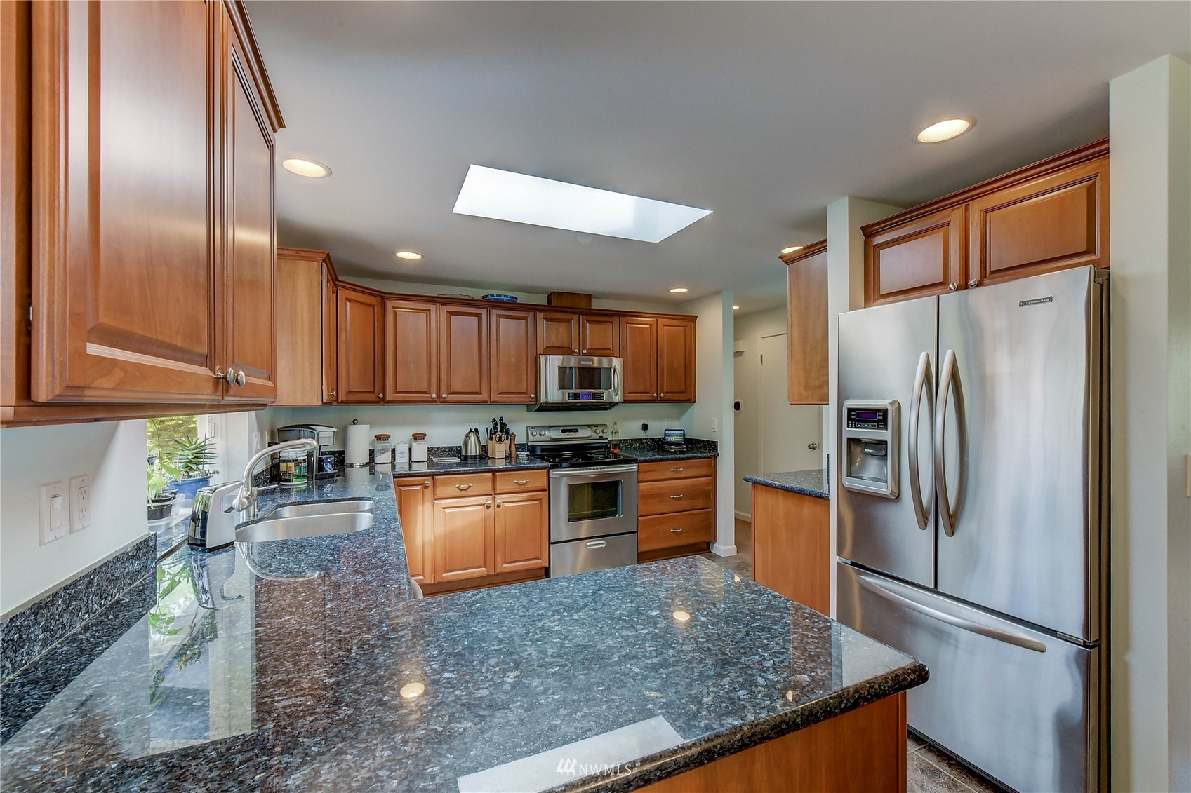22028 5th Avenue West Bothell, WA 98021 - Photo 5 of 19 a kitchen with granite countertop stainless steel appliances a refrigerator stove top oven and sink