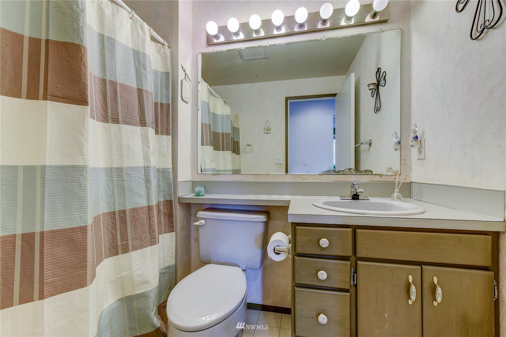 22028 5th Avenue West Bothell, WA 98021 - Photo 10 of 19 a bathroom with a granite countertop toilet sink and mirror