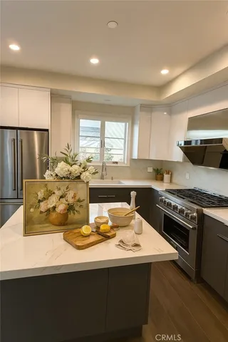 a kitchen with a stove a sink and a refrigerator