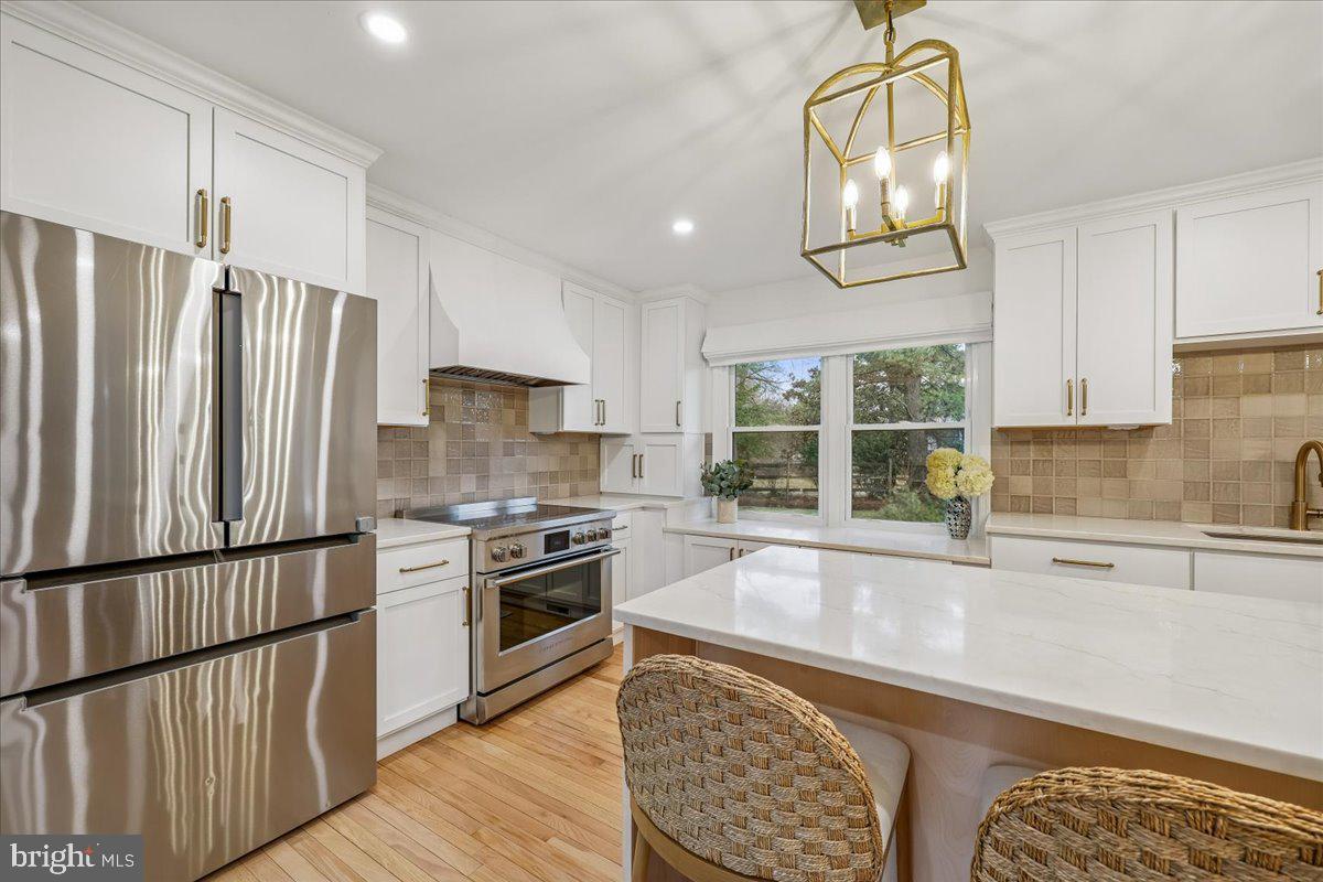 4 Olmstead Court Potomac, MD 20854 - Photo 12 of 48 a kitchen with stainless steel appliances granite countertop a stove a sink and a refrigerator