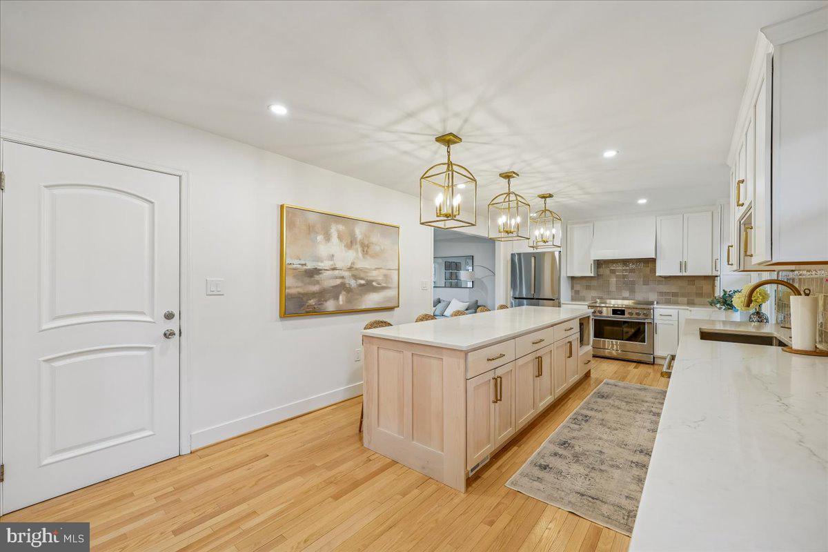 4 Olmstead Court Potomac, MD 20854 - Photo 20 of 48 a large kitchen with a sink and dishwasher a stove with wooden floor