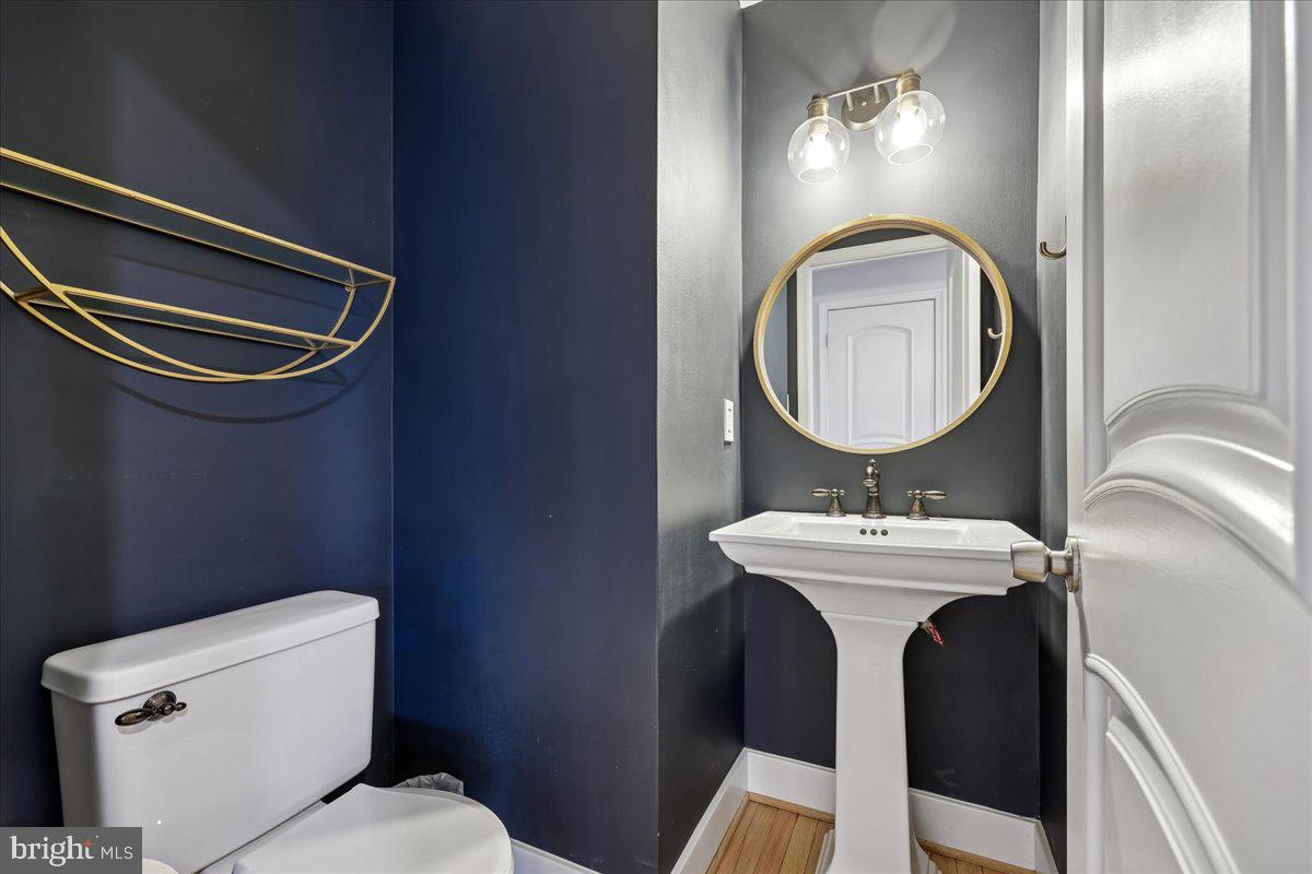 4 Olmstead Court Potomac, MD 20854 - Photo 26 of 48 a bathroom with a toilet a sink and mirror