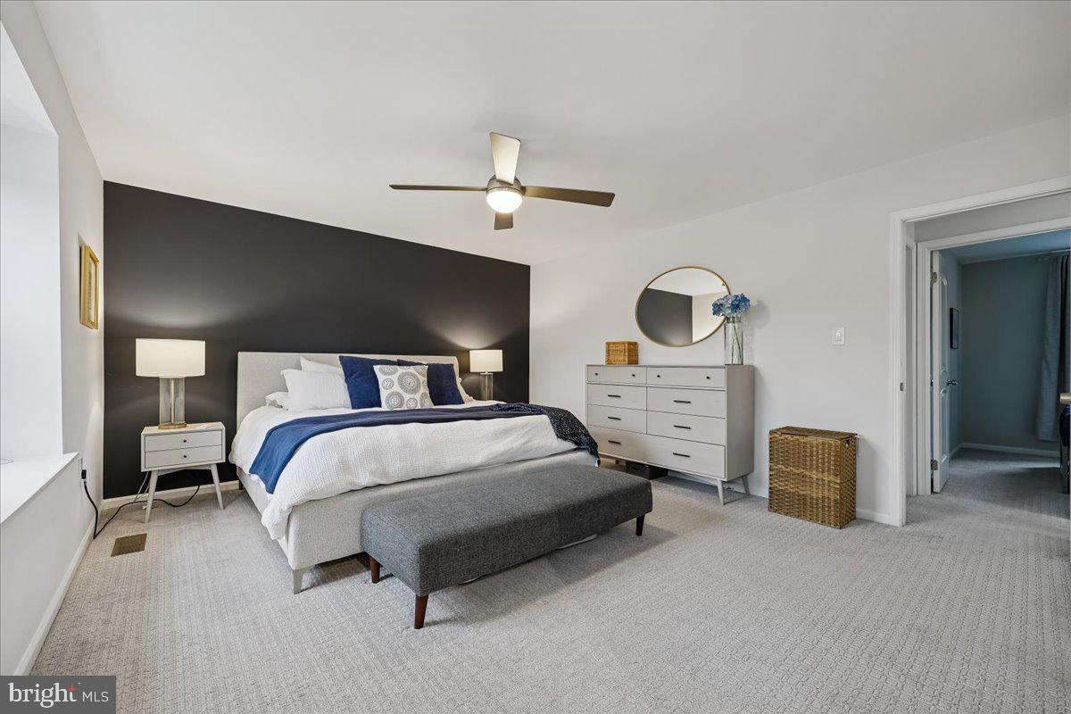 4 Olmstead Court Potomac, MD 20854 - Photo 28 of 48 a bedroom with a bed and a chandelier