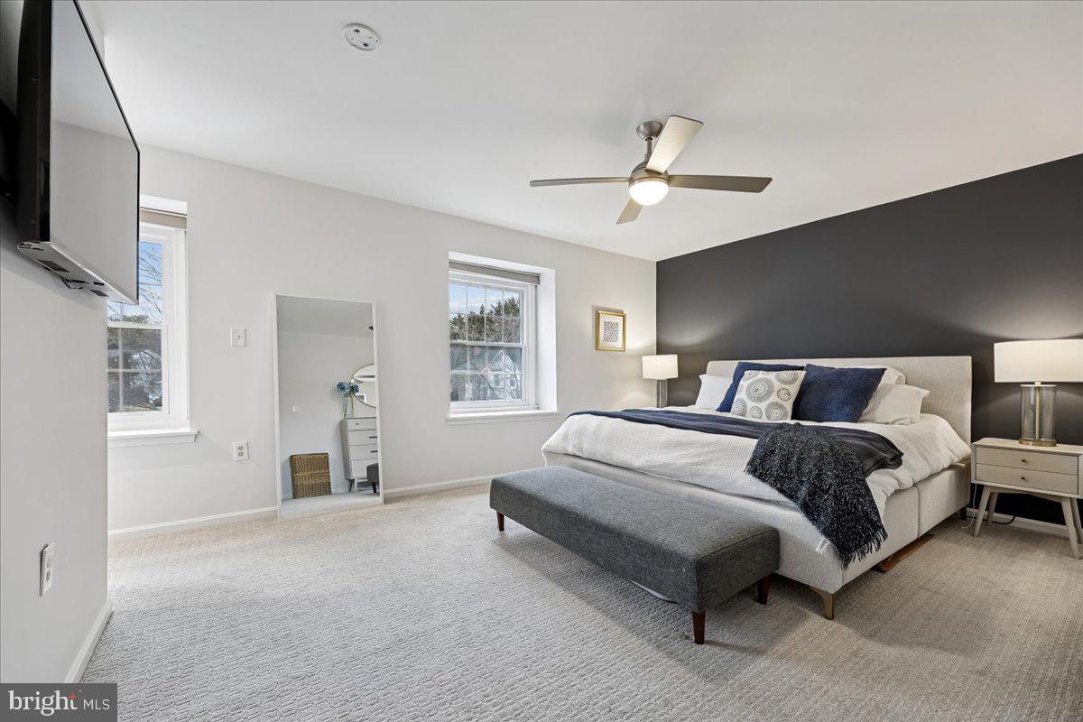 4 Olmstead Court Potomac, MD 20854 - Photo 29 of 48 a spacious bedroom with a bed and a flat screen tv