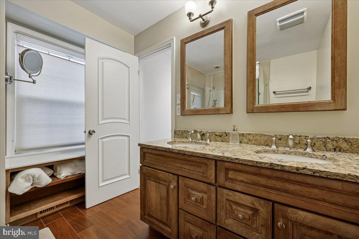4 Olmstead Court Potomac, MD 20854 - Photo 31 of 48 a bathroom with a sink and a mirror