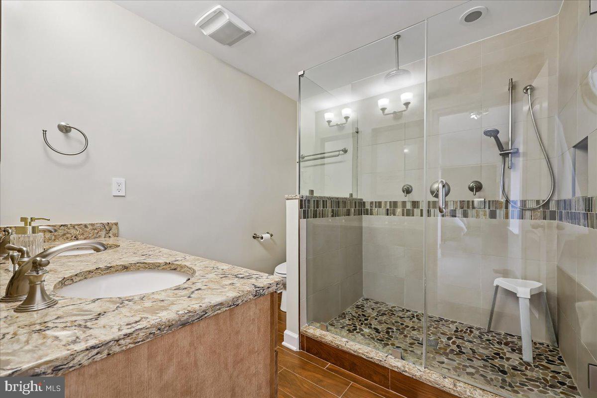 4 Olmstead Court Potomac, MD 20854 - Photo 32 of 48 a bathroom with a granite countertop sink and a mirror