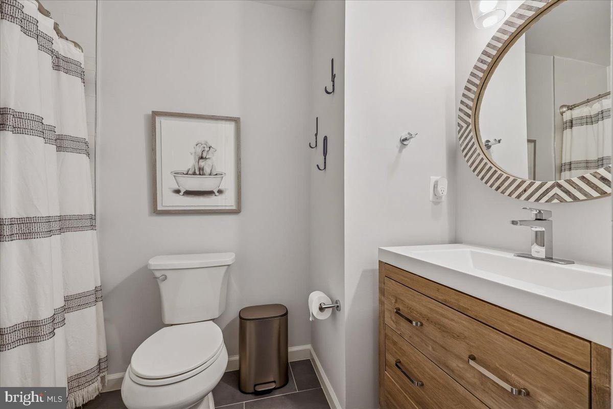 4 Olmstead Court Potomac, MD 20854 - Photo 36 of 48 a bathroom with a toilet a sink and mirror