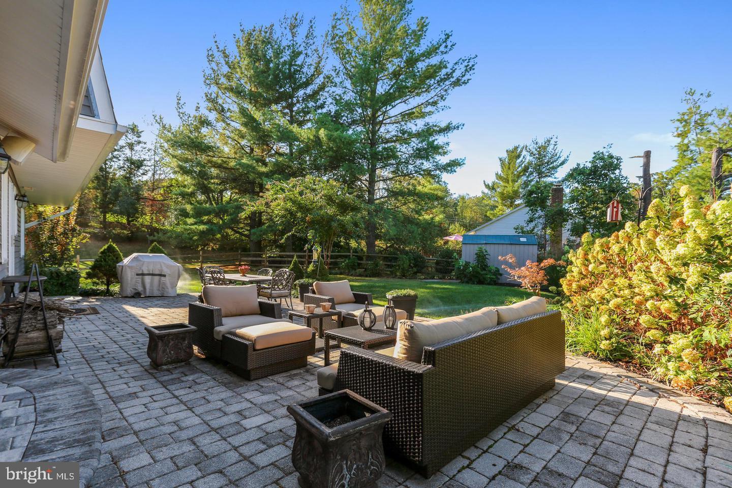 4 Olmstead Court Potomac, MD 20854 - Photo 46 of 48 a view of a patio with couches table and chairs and potted plants