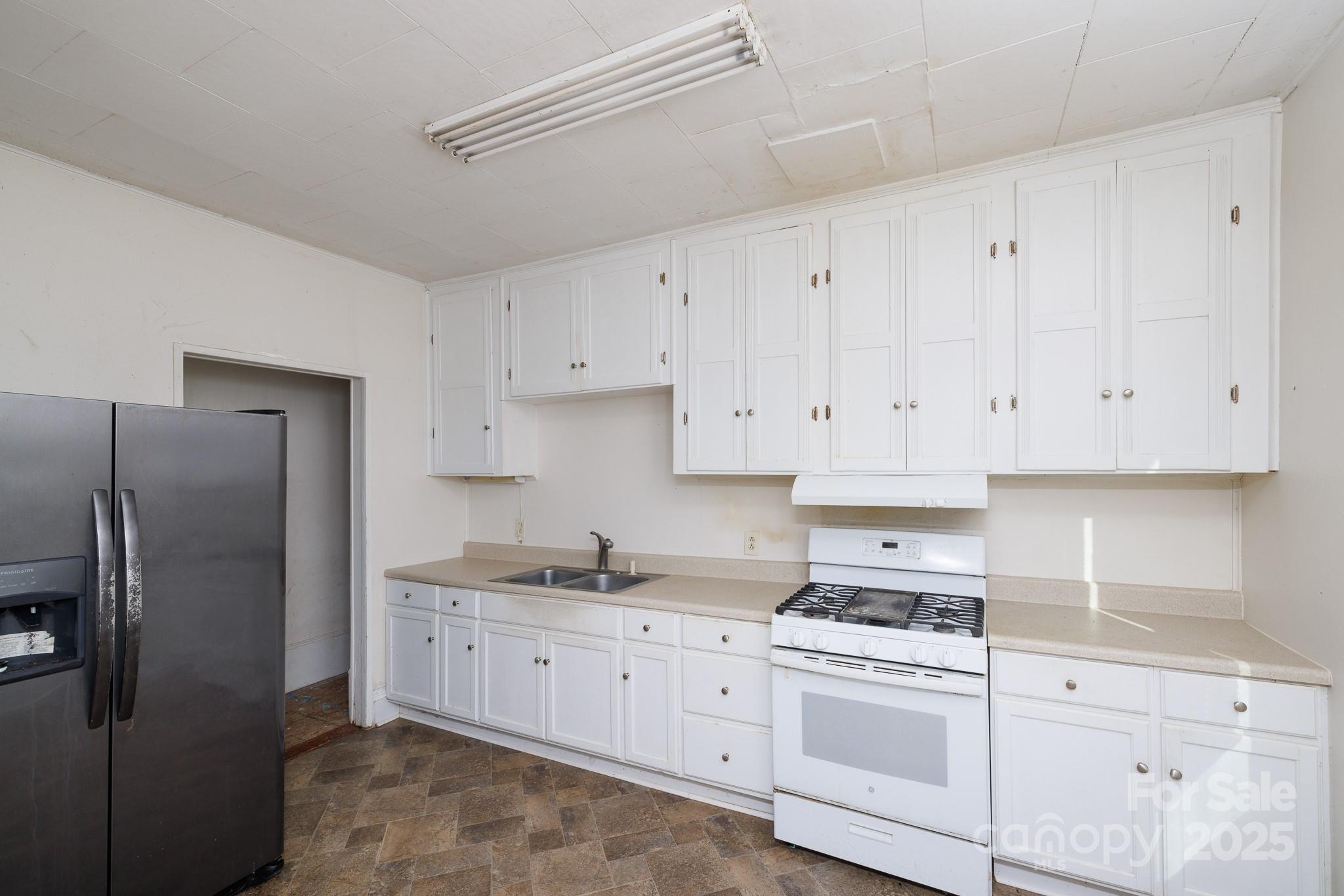609 Bethel Street Clover, SC 29710 - Photo 11 of 19 a kitchen with cabinets stainless steel appliances and a counter space