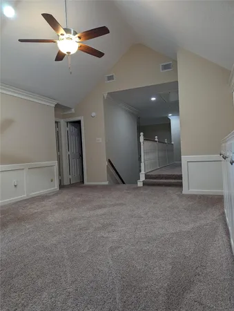 a view of a livingroom with a ceiling fan and window