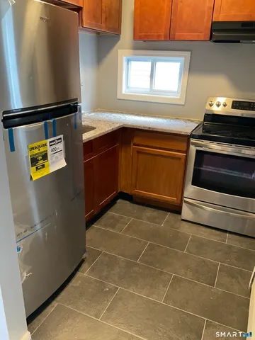 a kitchen with a stove and a refrigerator