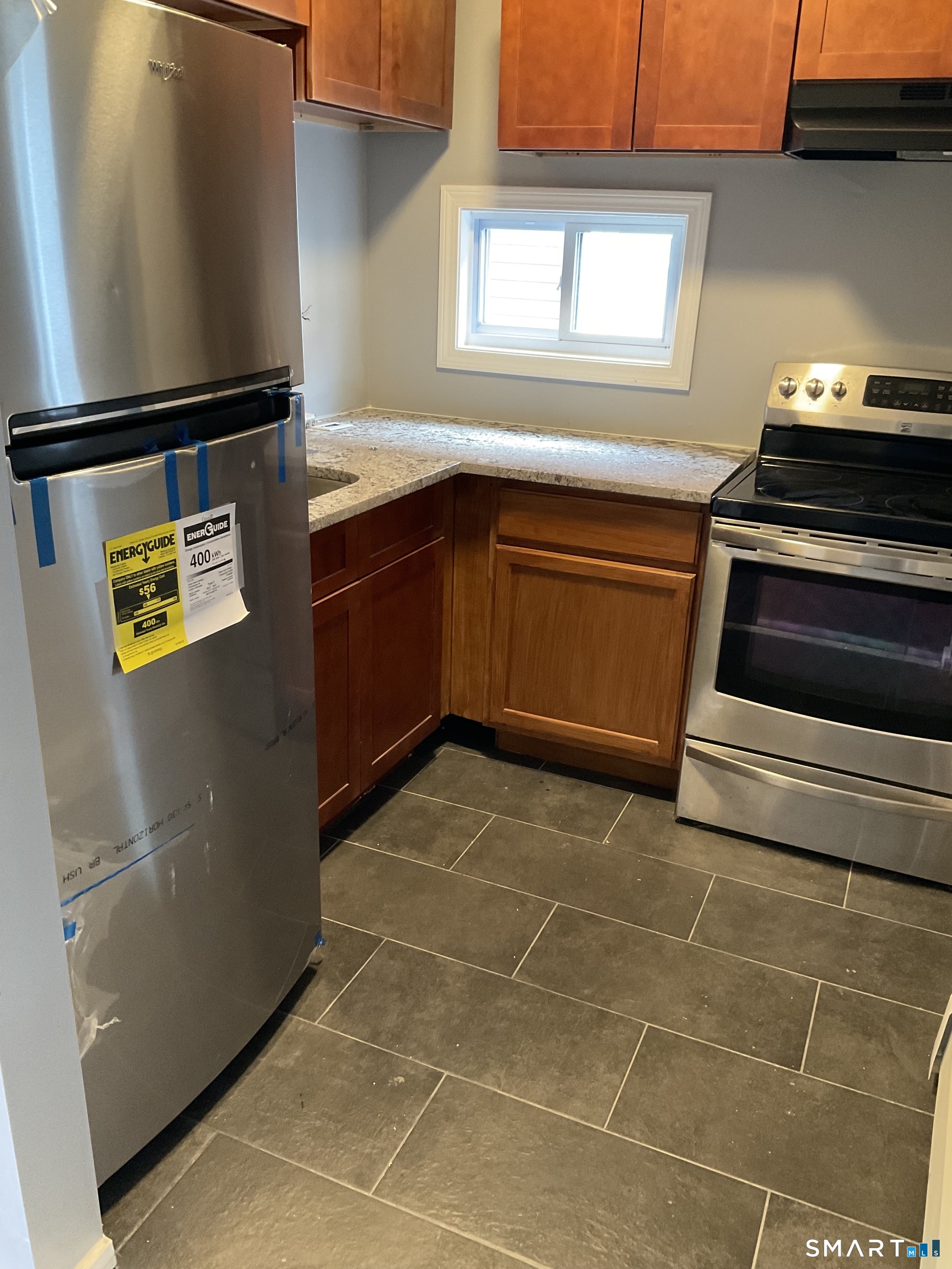 589 Winchester Avenue, Unit 3 New Haven, CT 06511 - Photo 3 of 11 a kitchen with a stove and a refrigerator