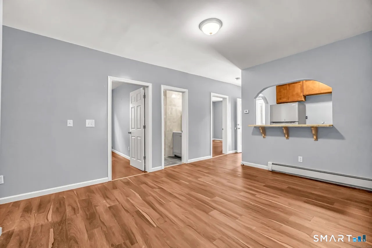 589 Winchester Avenue, Unit 3 New Haven, CT 06511 - Photo 5 of 11 an empty room with a window and wooden floor