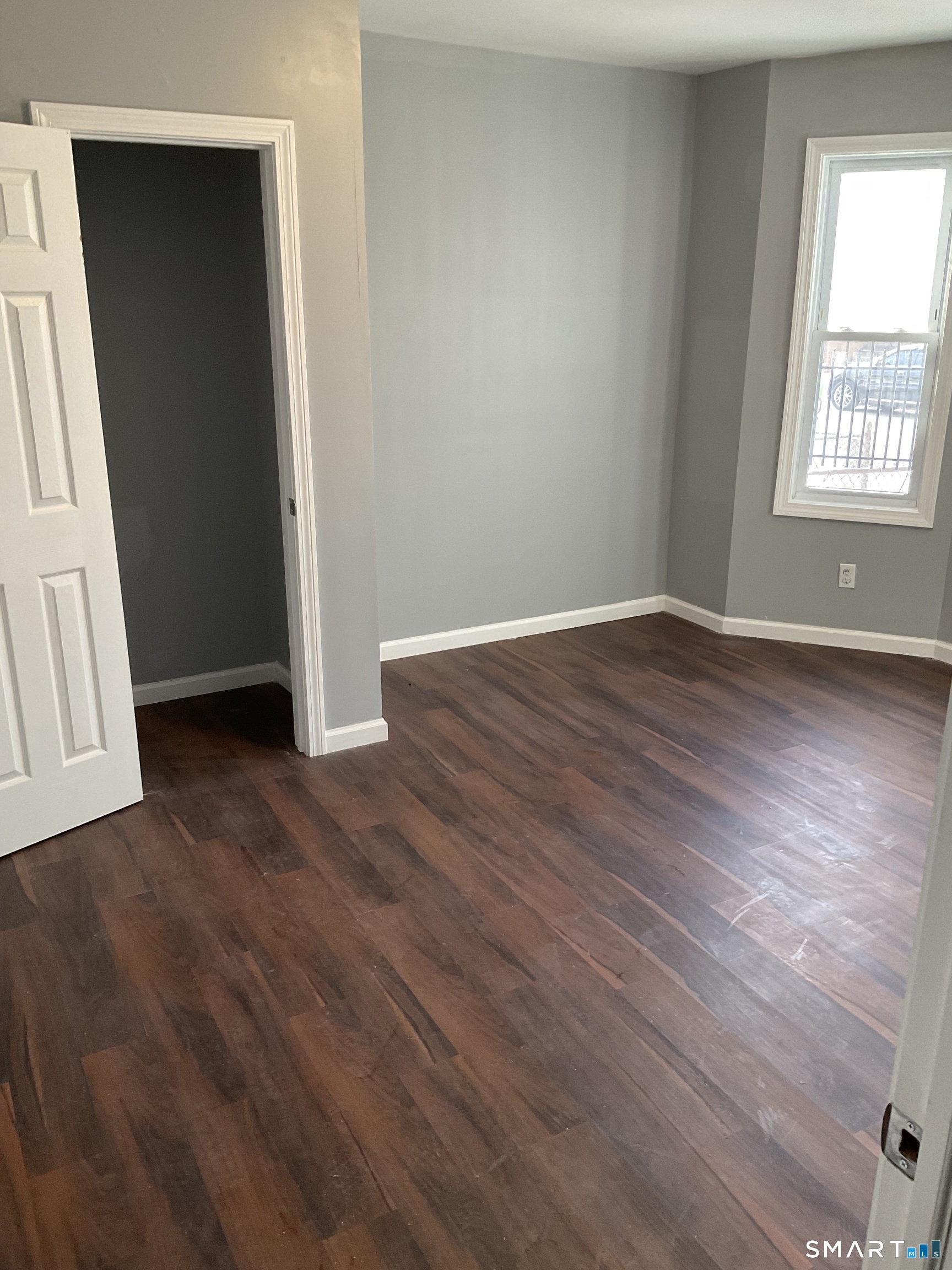589 Winchester Avenue, Unit 3 New Haven, CT 06511 - Photo 9 of 11 an empty room with wooden floor and windows