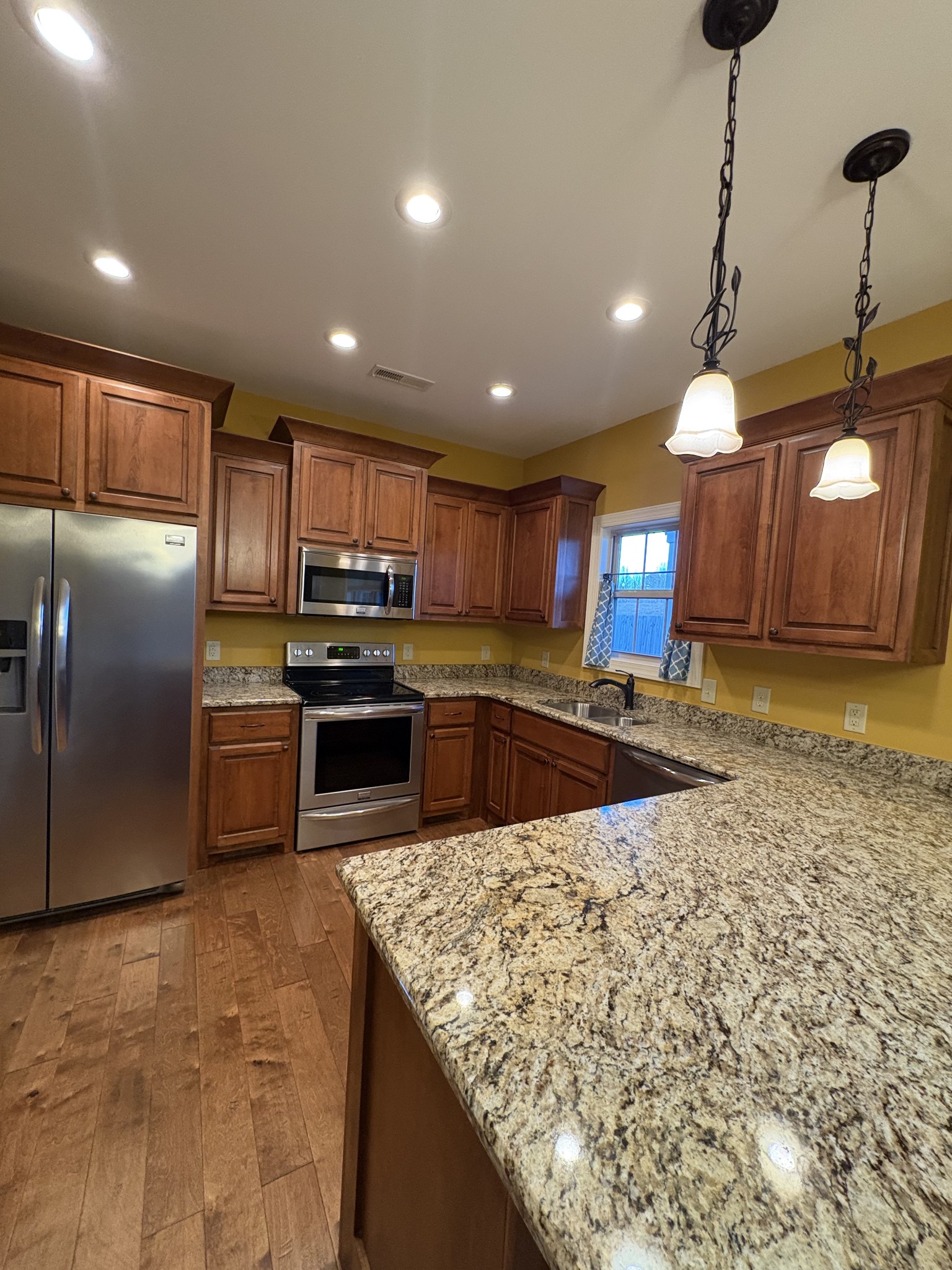117 Grayson Lane White House, TN 37188 - Photo 8 of 24 a kitchen with stainless steel appliances granite countertop a sink a stove and a refrigerator
