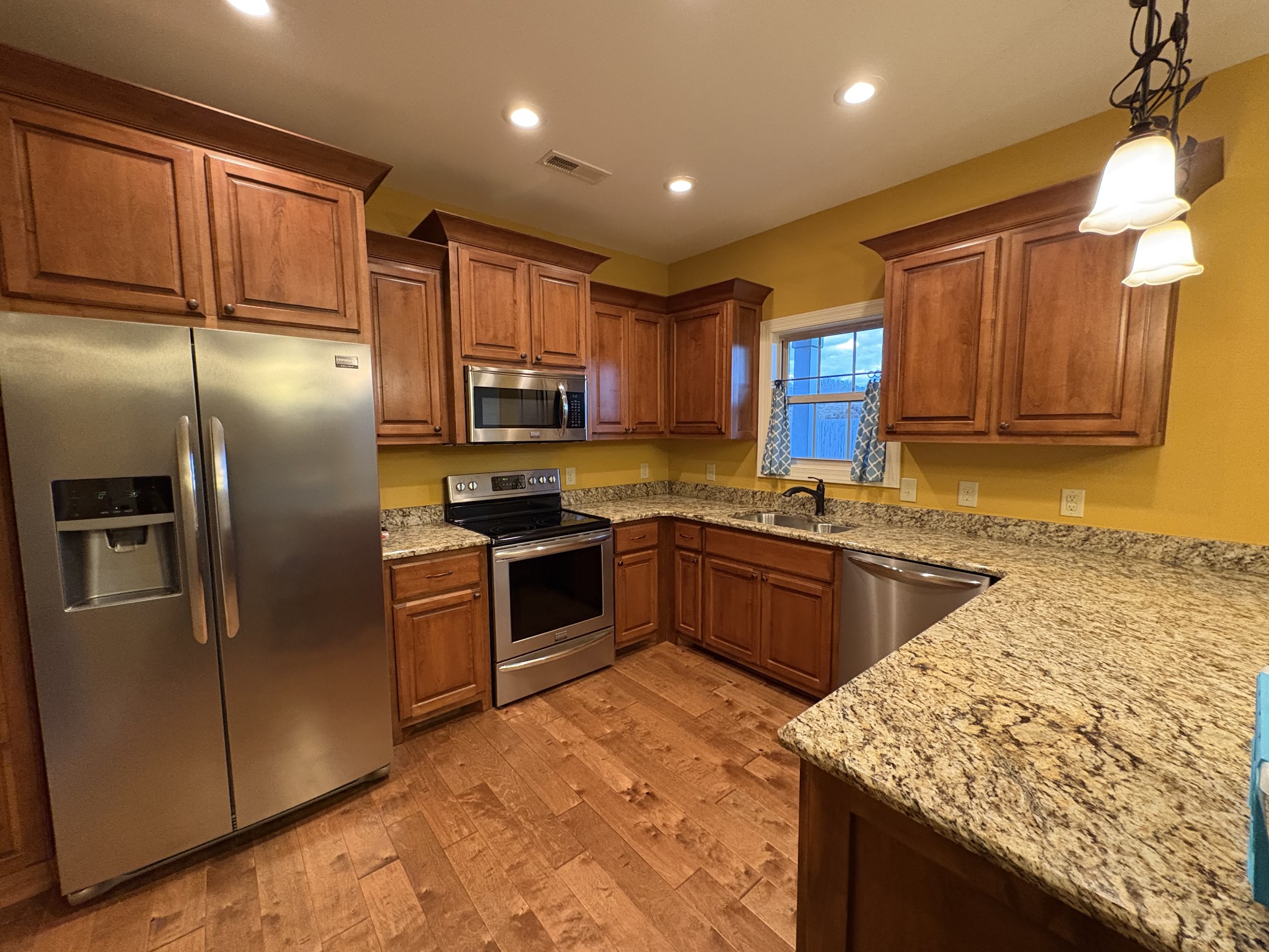 117 Grayson Lane White House, TN 37188 - Photo 9 of 24 a kitchen with stainless steel appliances granite countertop a refrigerator a stove a sink and a microwave