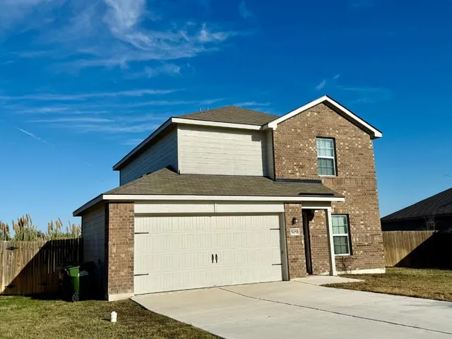 a front view of a house with a garage