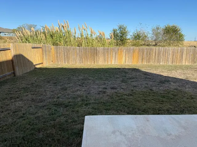 a view of swimming pool with a yard