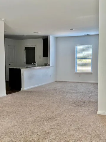 an empty room with a ceiling fan and a window