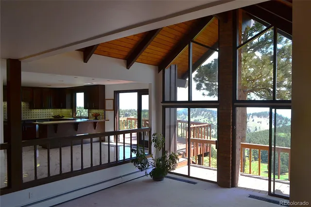 a view of a balcony with wooden floor and fence