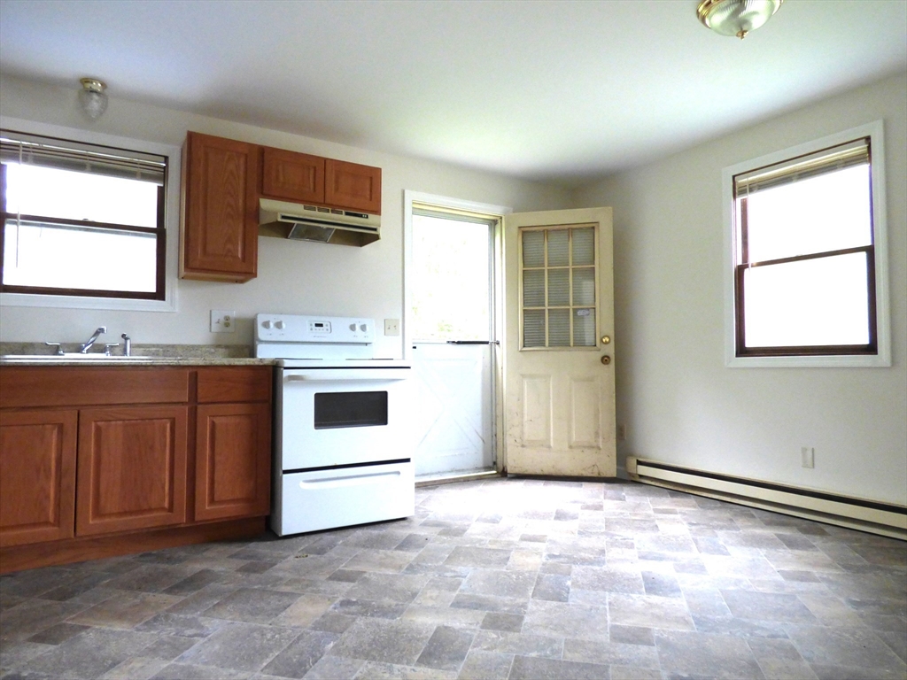 26-28 Daniel Street Springfield, MA 01151 - Photo 6 of 15 a kitchen with stainless steel appliances a stove and white cabinets