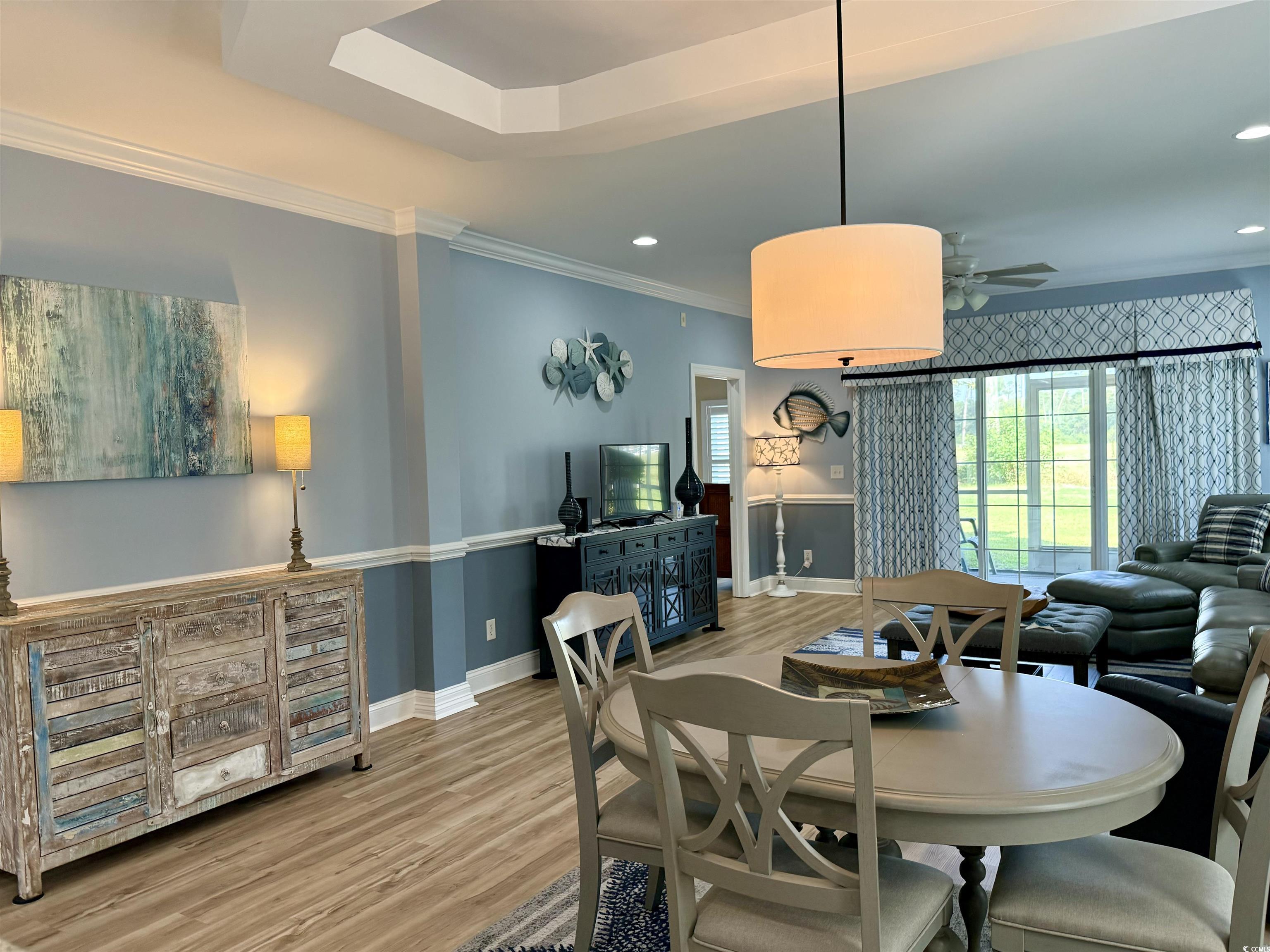 1008 Ray Costin Way, Unit 305 Murrells Inlet, SC 29576 - Photo 13 of 31 Dining room featuring crown molding, hardwood / wo