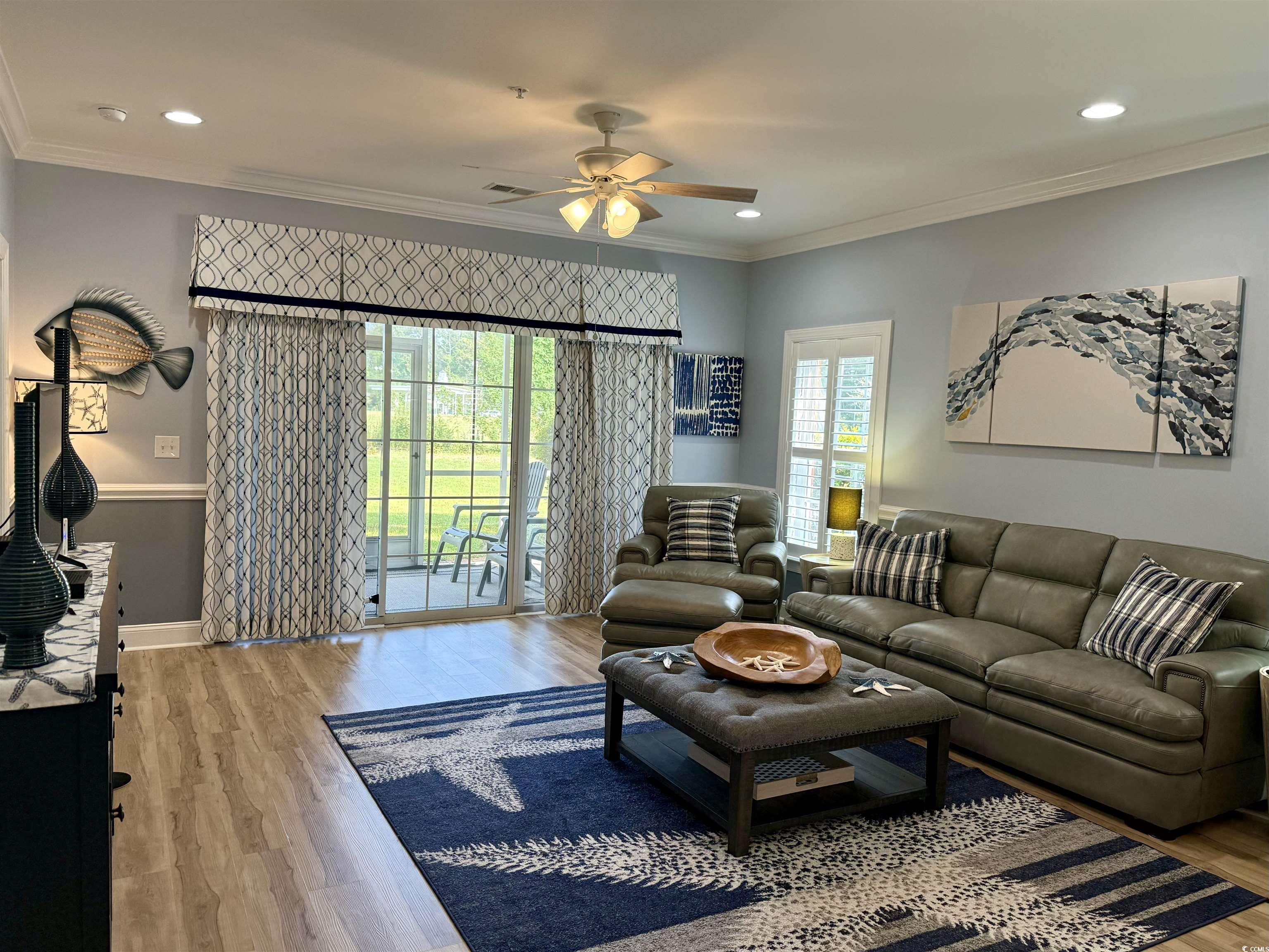 1008 Ray Costin Way, Unit 305 Murrells Inlet, SC 29576 - Photo 16 of 31 Living room with crown molding, hardwood / wood-st