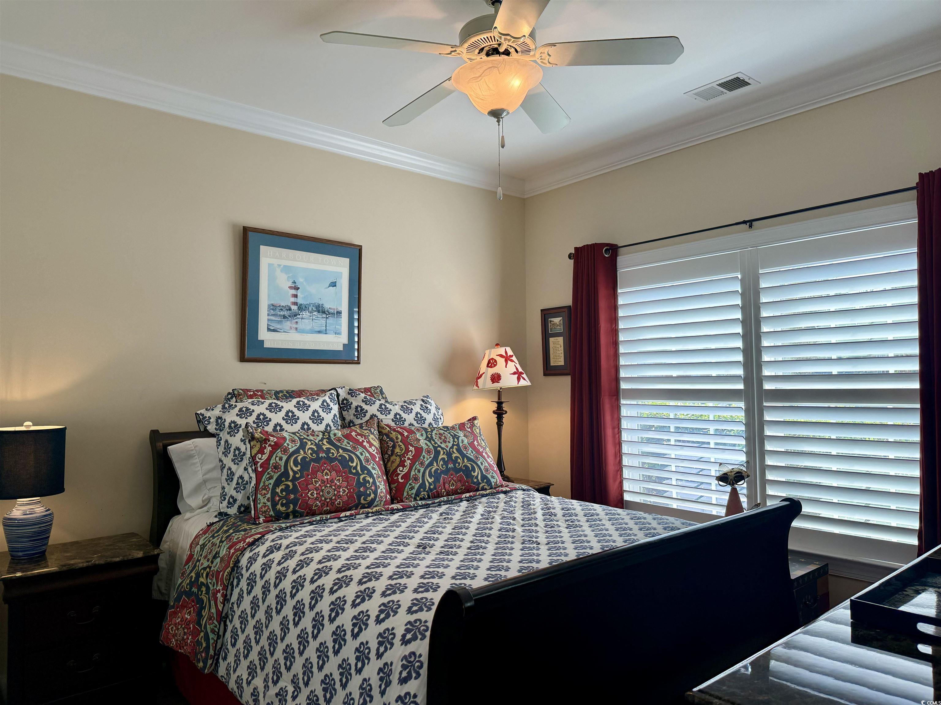 Bedroom with crown molding and ceiling fan