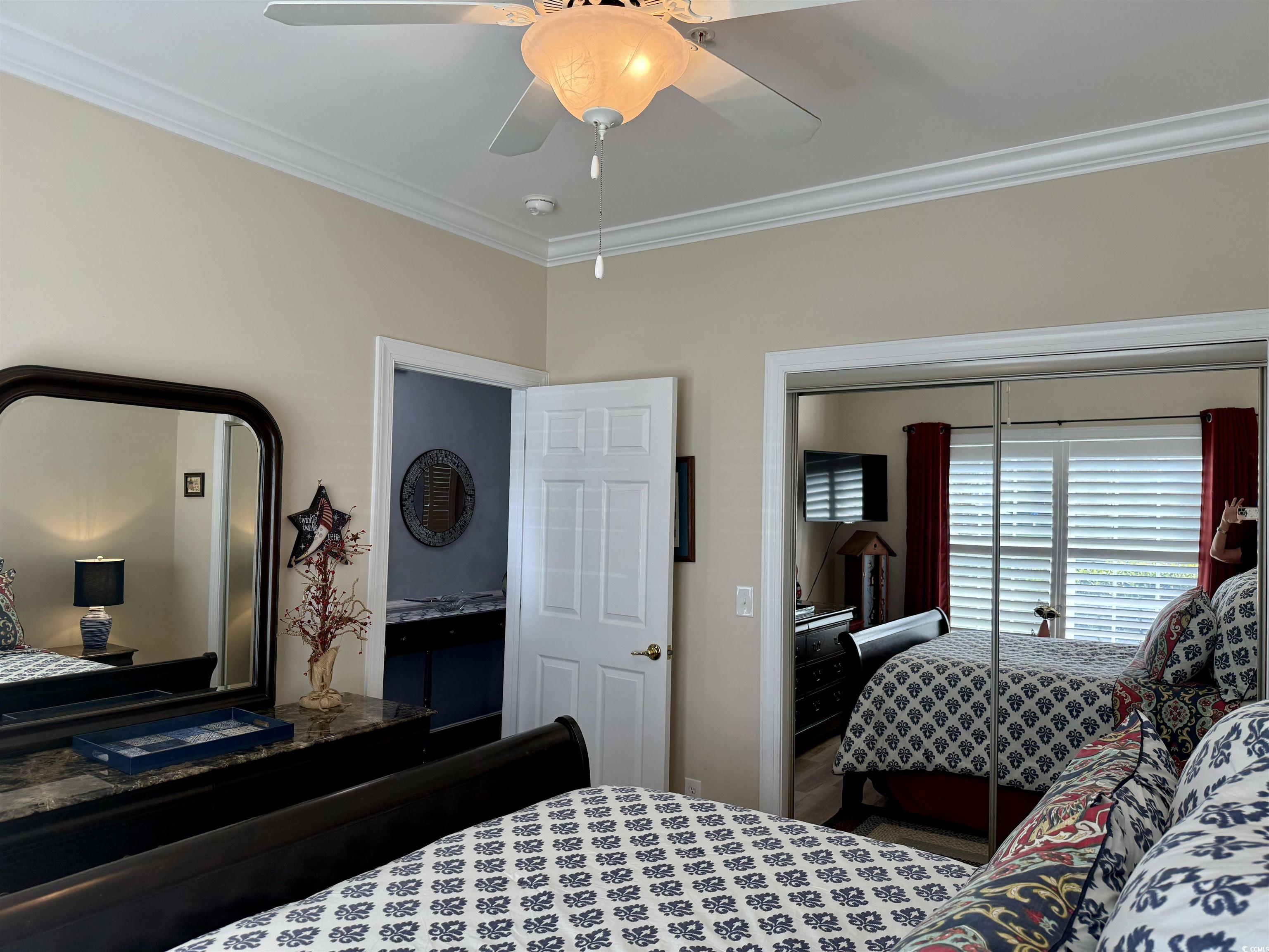 Bedroom featuring a closet, ornamental molding, an