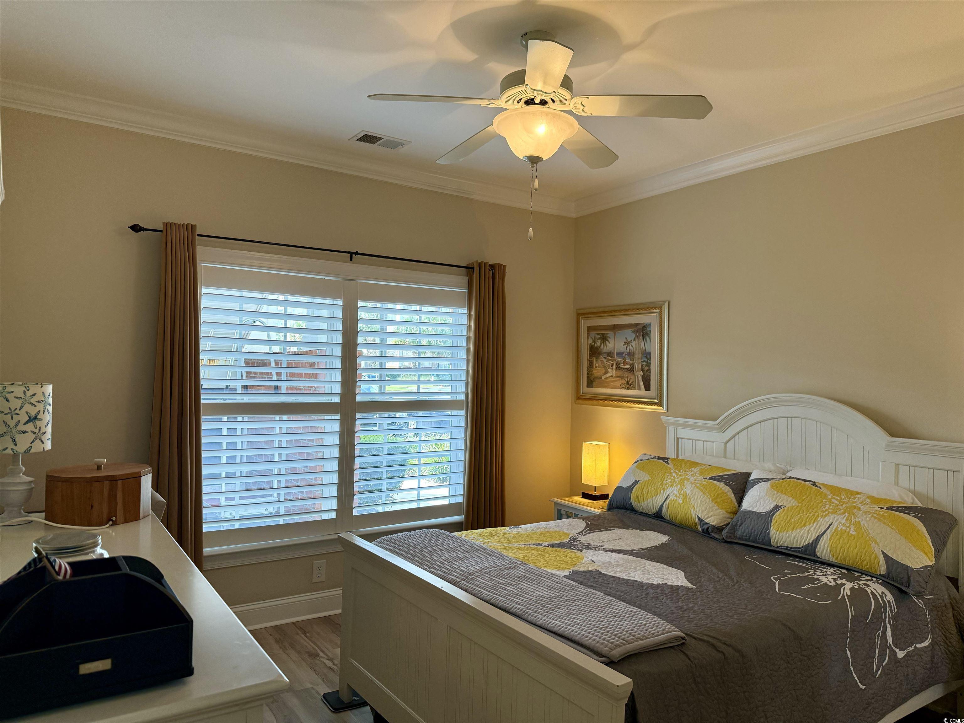 Bedroom featuring ceiling fan, wood-type flooring,