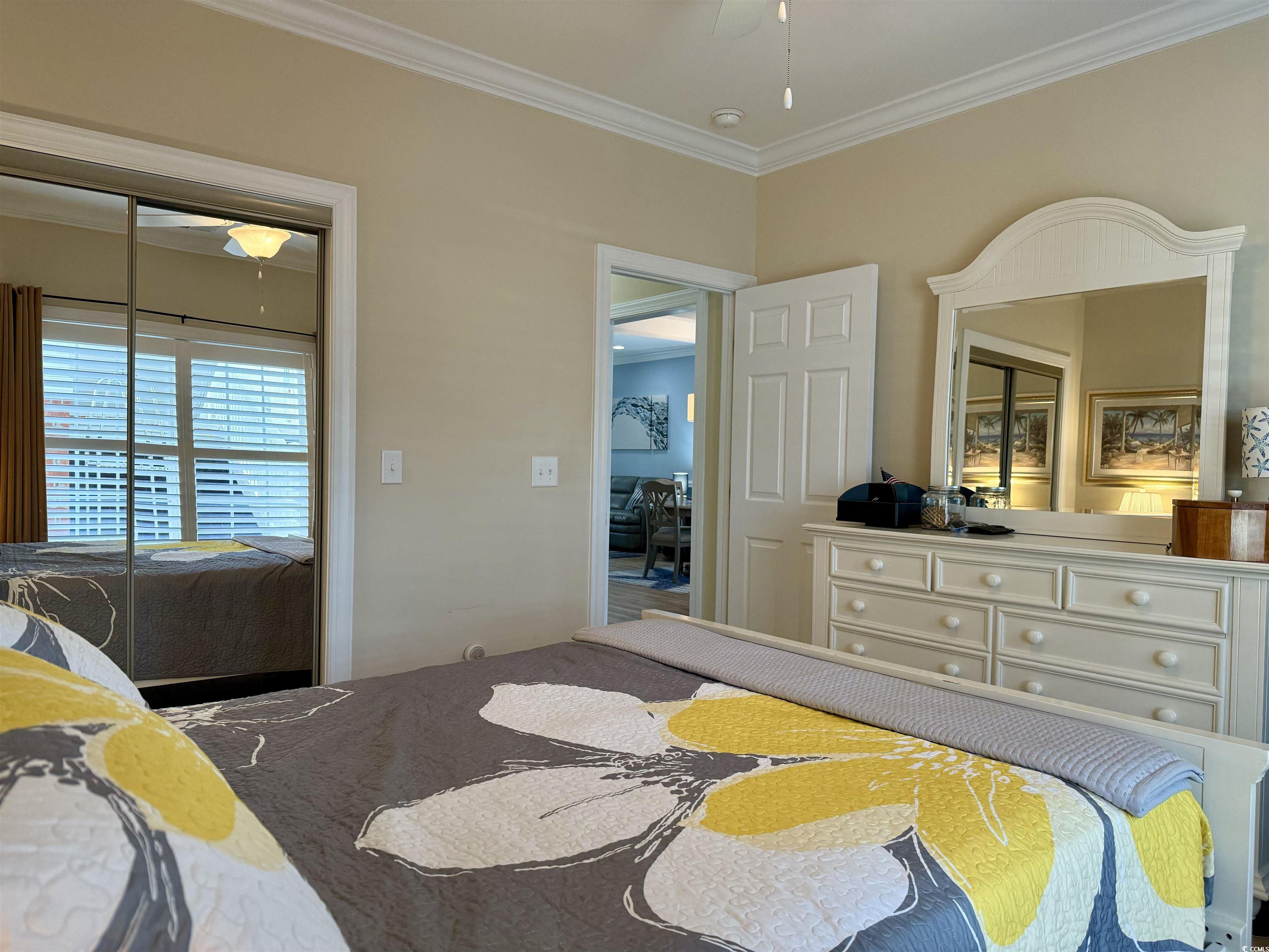 1008 Ray Costin Way, Unit 305 Murrells Inlet, SC 29576 - Photo 9 of 31 Bedroom featuring a closet, ceiling fan, and ornam
