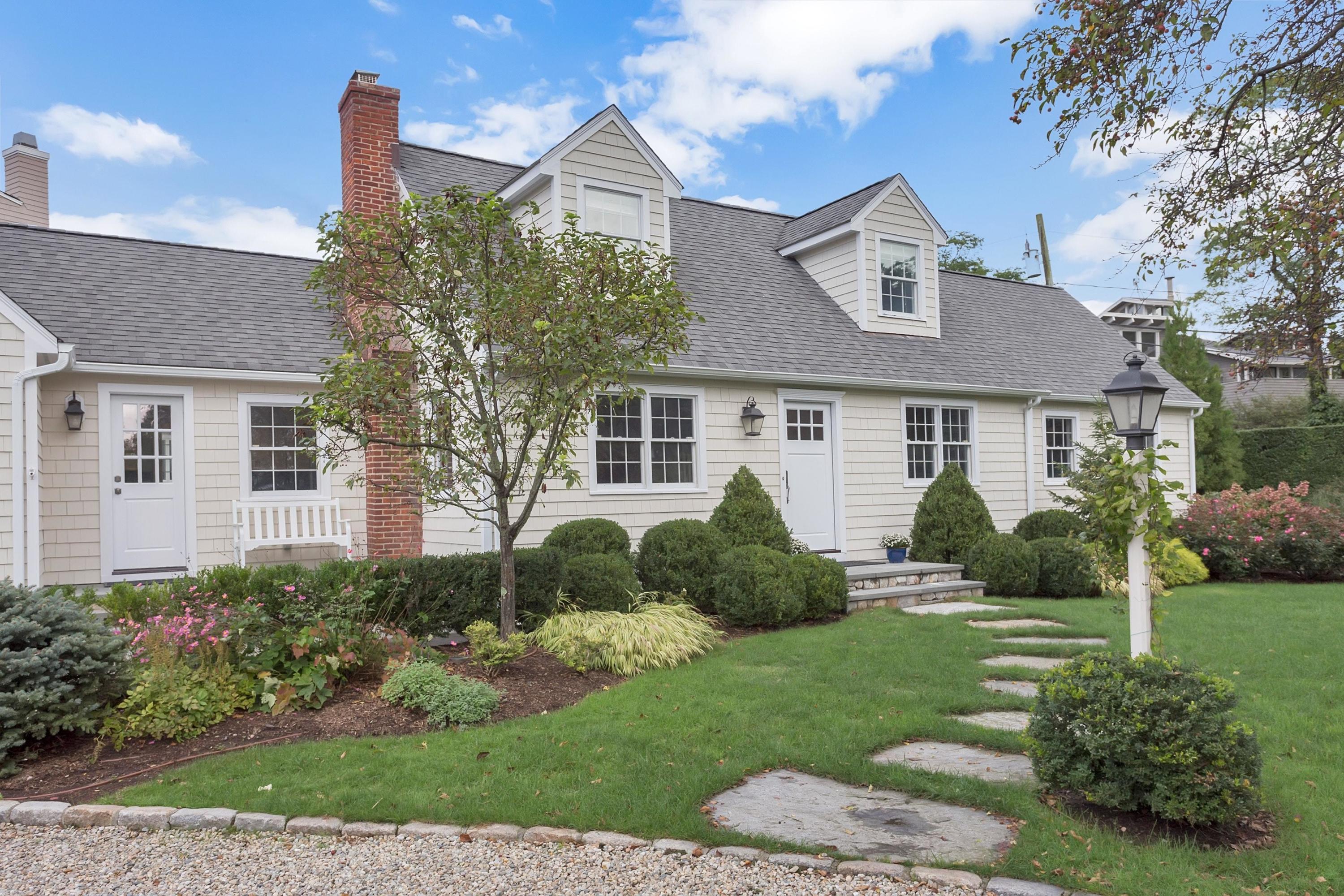 31 Meridian Road Rowayton, CT 06853 - Photo 2 of 18 a front view of a house with a yard and outdoor seating