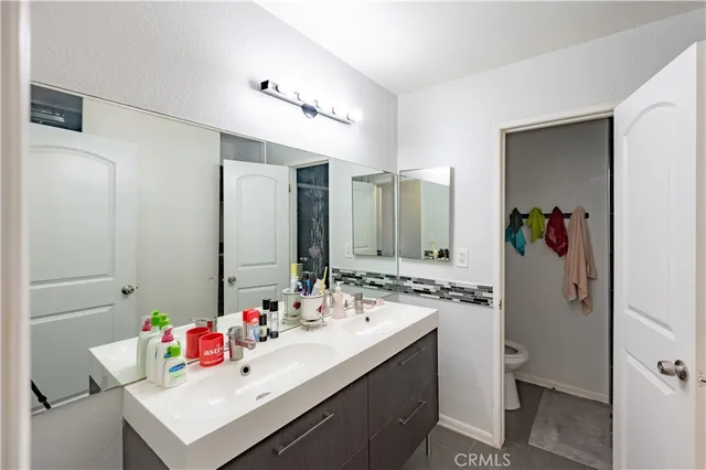 a bathroom with a sink mirror vanity and toilet