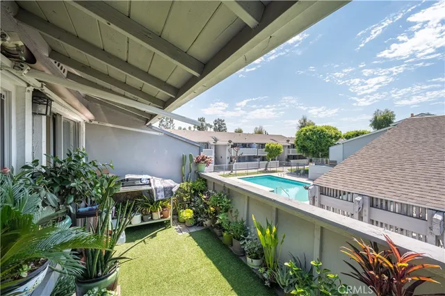 a view of a wrought iron fences in front of a yard with wooden fence