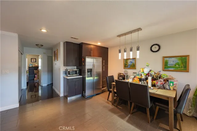 a kitchen with stainless steel appliances granite countertop stove top oven and cabinets